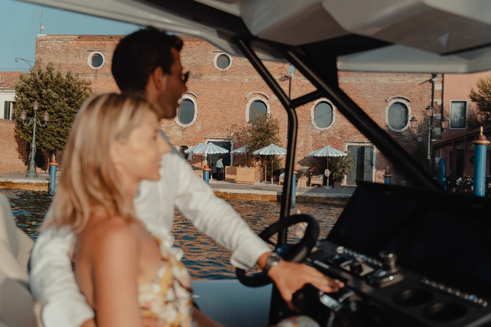 Couple in the cockpit of a Highfield boat in a Venice canal